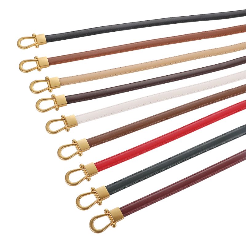 Ceintures fines Nuance en cuir avec fermoirs dorés, disponibles en plusieurs couleurs : noir, marron clair, beige, marron foncé, blanc, rouge, vert foncé et bordeaux.