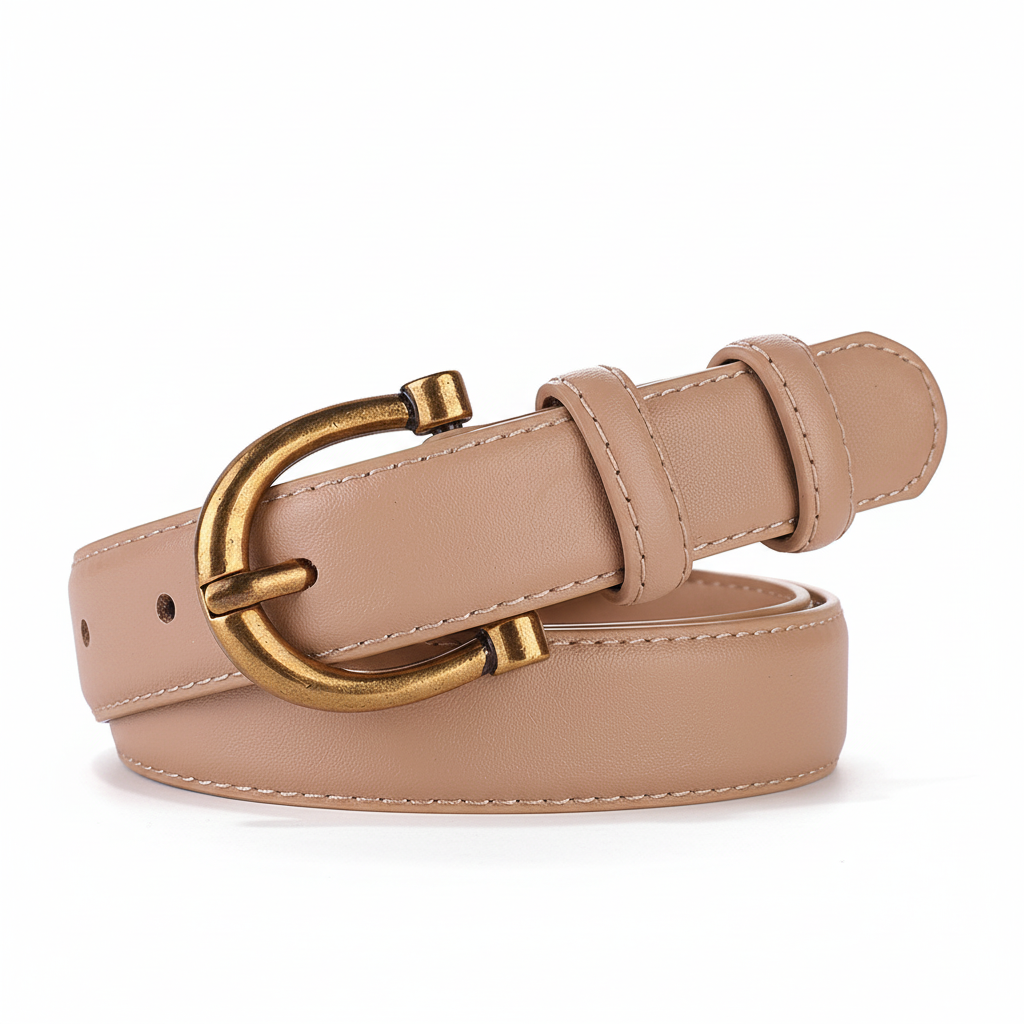 Ceinture femme Prisca en cuir beige avec boucle ardillon arrondie finition bronze patiné. Lanière fine de 2,3 cm de largeur.